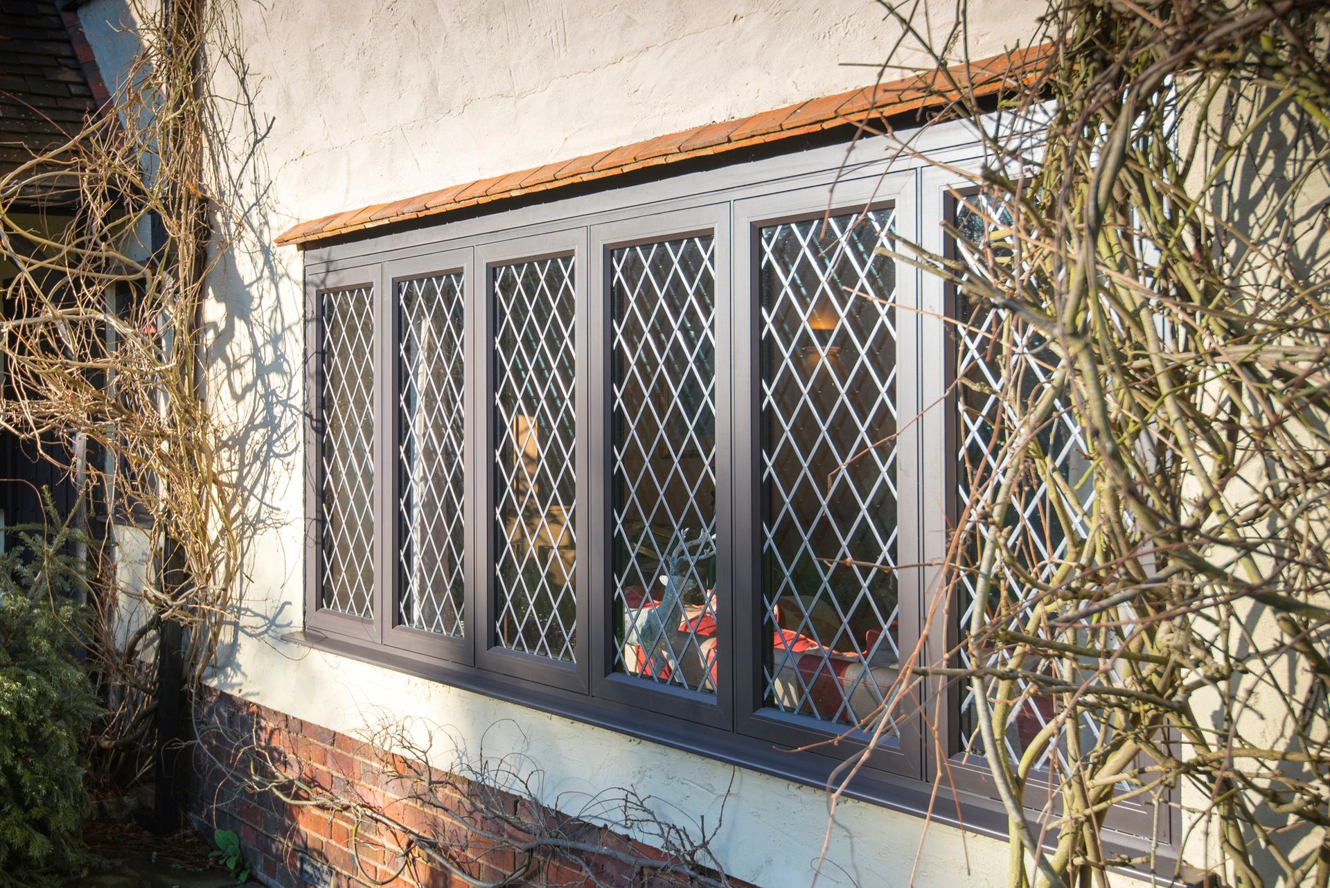 A window on the side of a building with a fence around it.