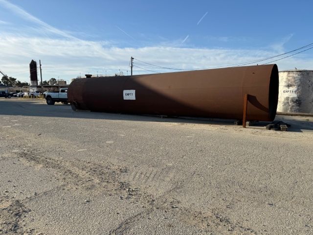 A Large Brown Pipe Is Sitting in A Parking Lot