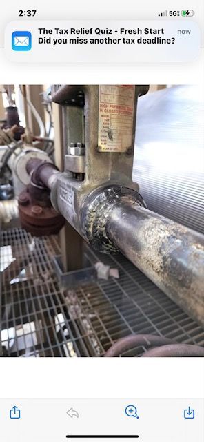 A phone screen shows a picture of a pipe.