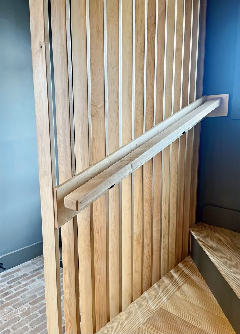A wooden wall with a railing attached to it.