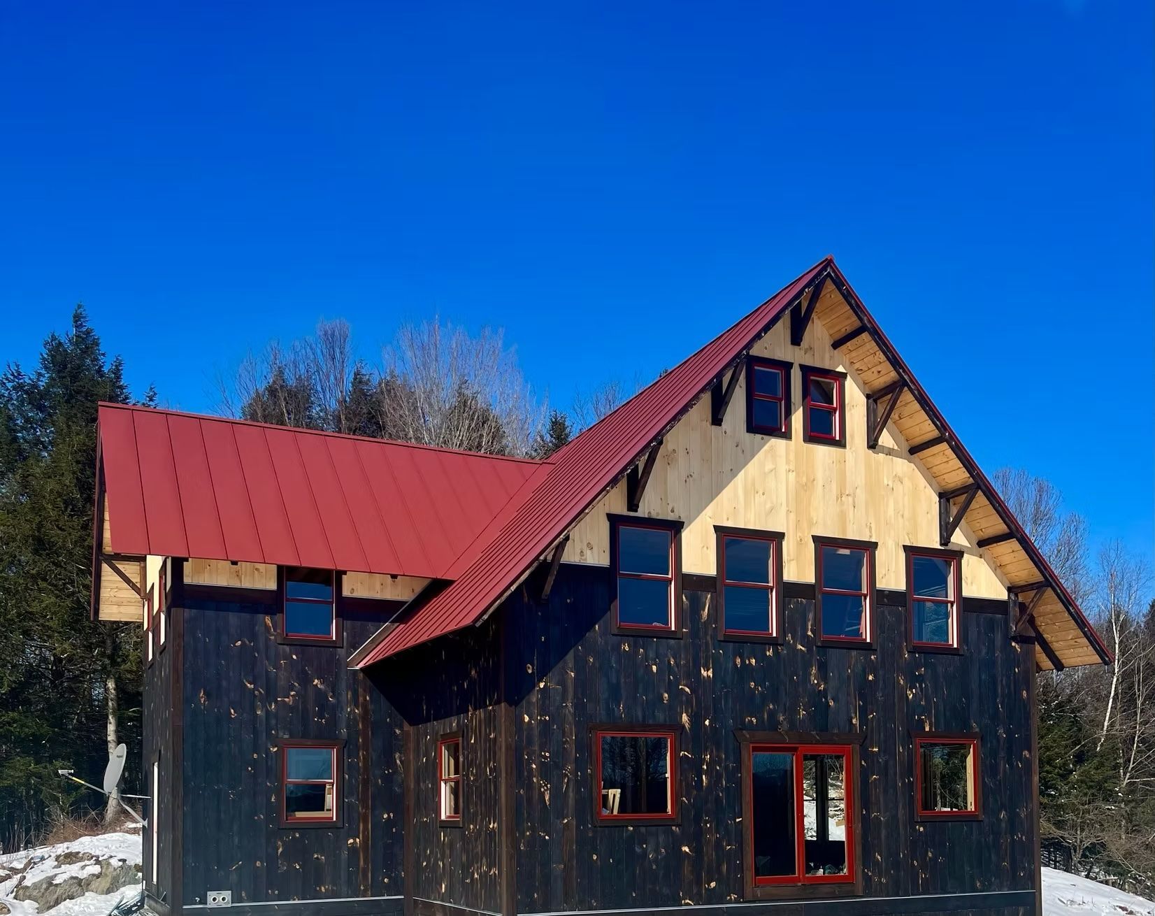 A house with a red roof and a lot of windows
