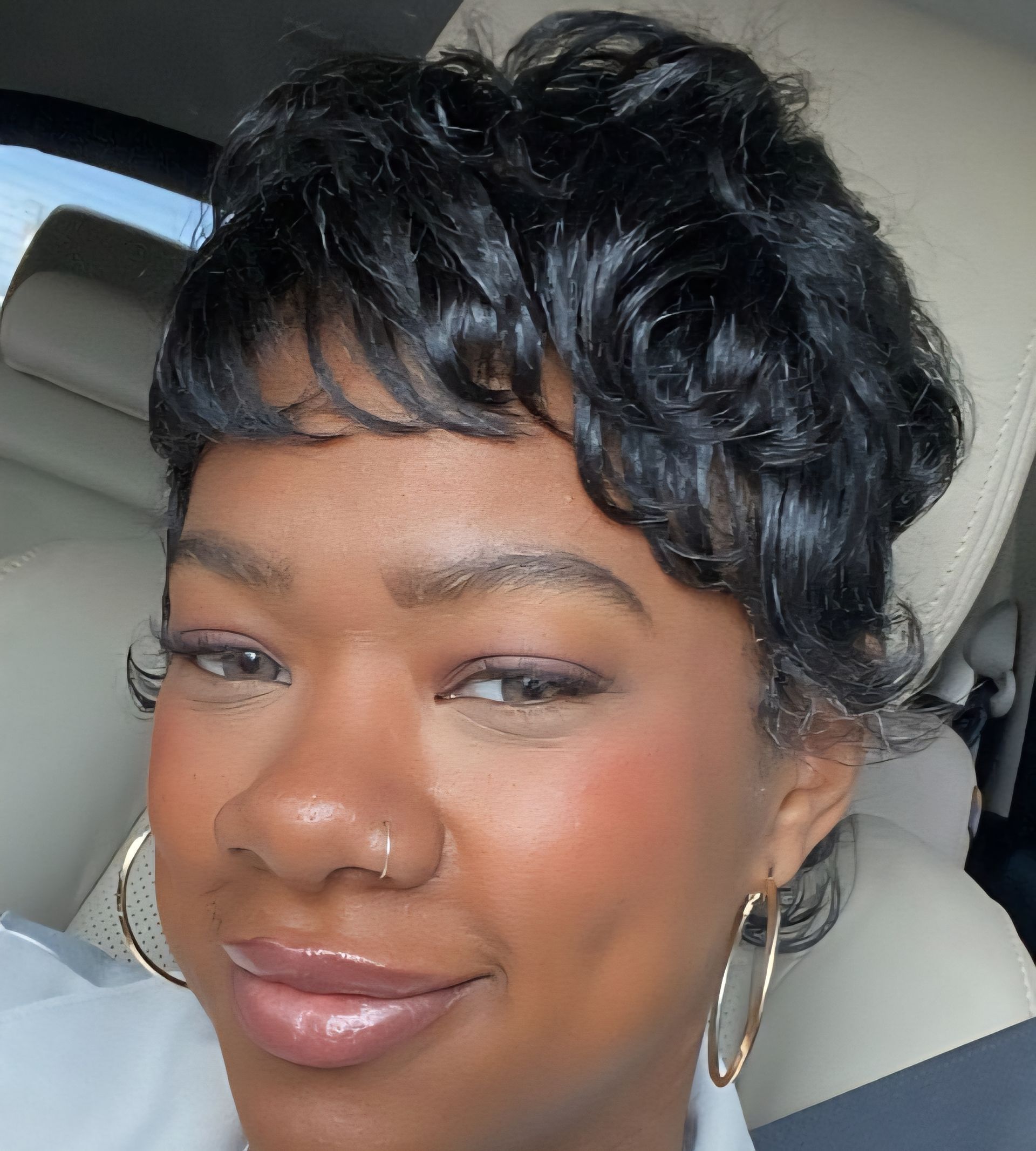 A close up of a woman 's face with a wig on.