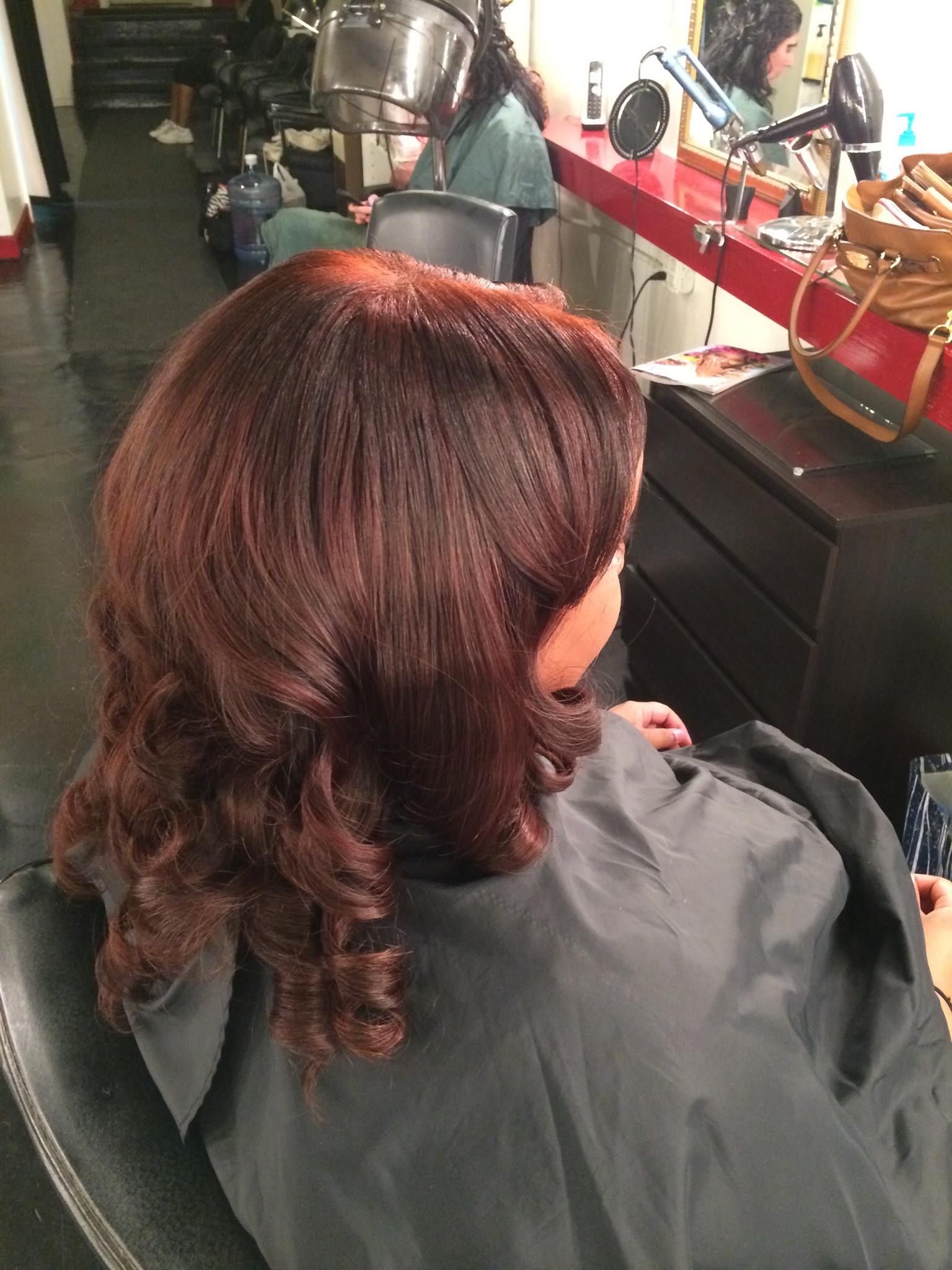 A woman is getting her hair cut at a salon