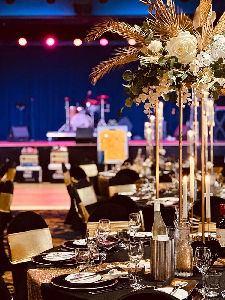 A Table Set for a Wedding Reception With Flowers and Candles on It — Central Coast Events in Berkeley Vale, NSW