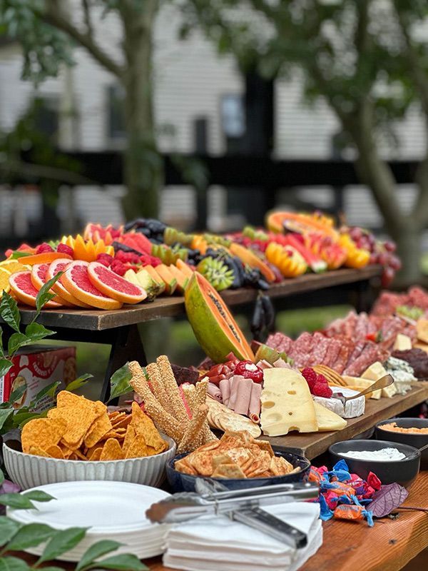 A Wooden Table Topped With Plates of Food and Fruit — Central Coast Events in Berkeley Vale, NSW