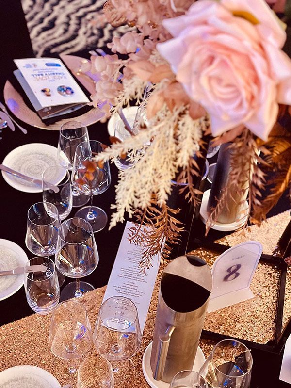 A Table With Plates, Wine Glasses, and Flowers on It — Central Coast Events in Berkeley Vale, NSW