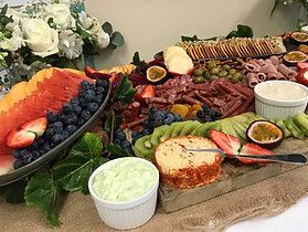 A Wooden Cutting Board Topped With a Variety of Fruits and Vegetables ― Central Coast Events in Berkeley Vale, NSW