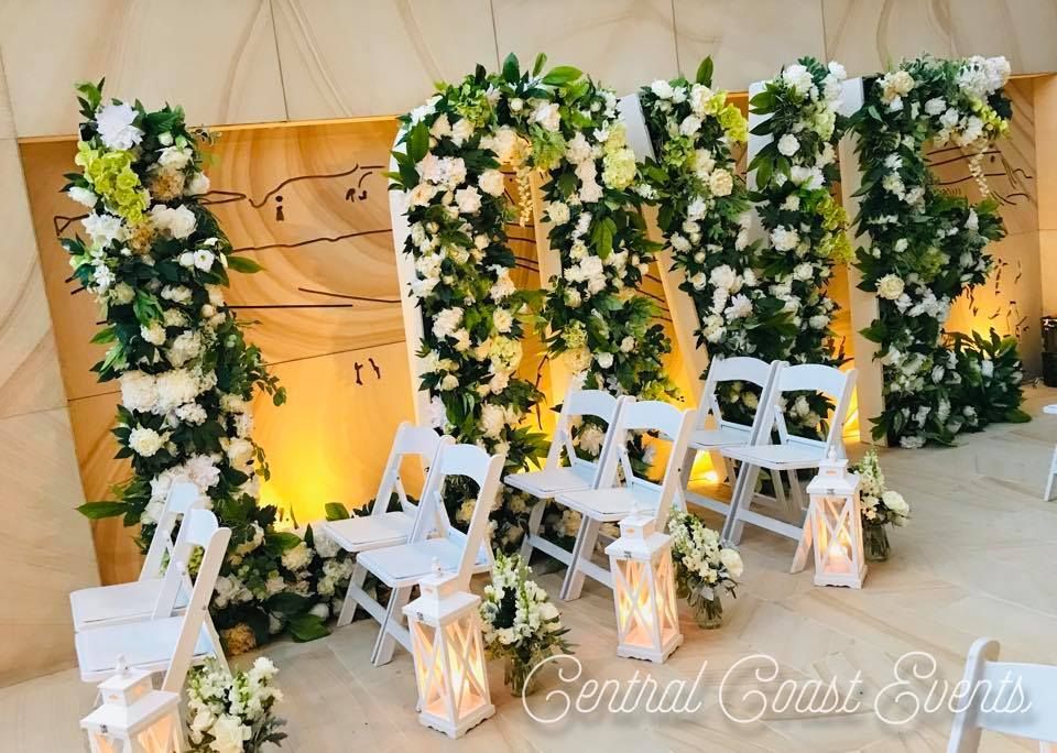 The Word Love is Surrounded by Flowers and Chairs — Central Coast Events in Newcastle, NSW