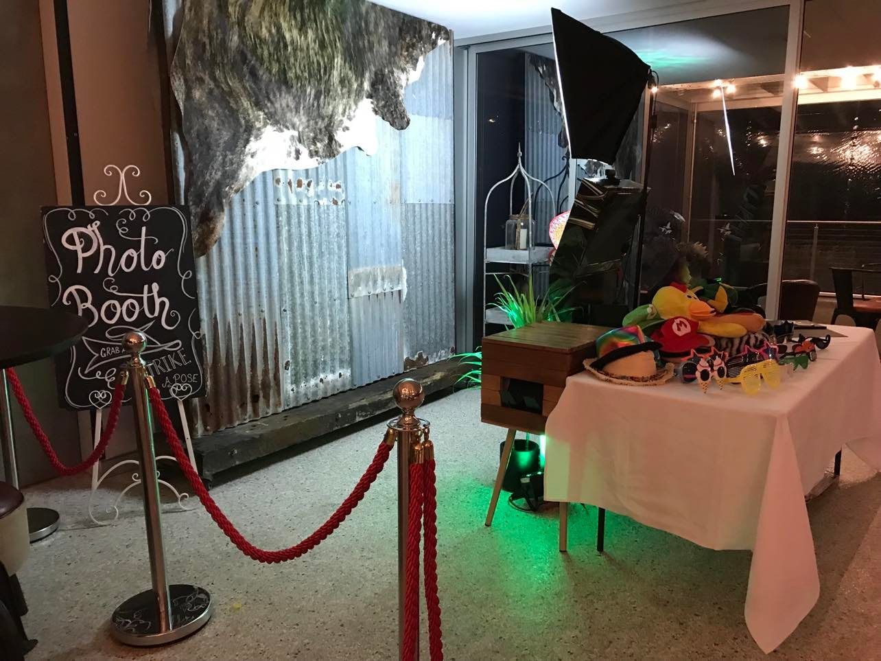 A Photo Booth With A Tin Background And Table With Hats
 — Central Coast Events in Berkeley Vale, NSW