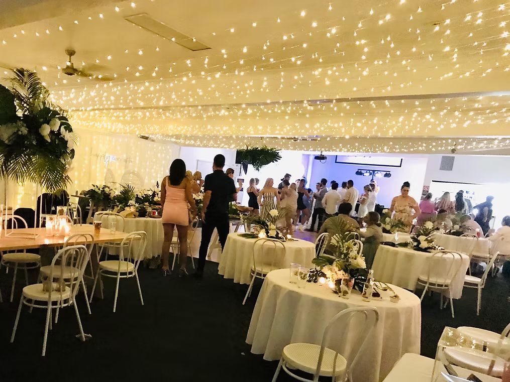 A Large Room With Tables and Chairs Set Up for a Wedding Reception ― Central Coast Events in Berkeley Vale, NSW