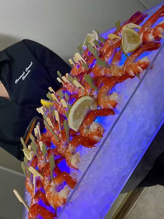 A Person is Holding a Tray of Shrimp on Ice ― Central Coast Events in Berkeley Vale, NSW