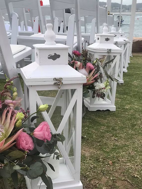 A Row of White Lanterns Sitting on Top of a Lush Green Field ― Central Coast Events in Berkeley Vale, NSW