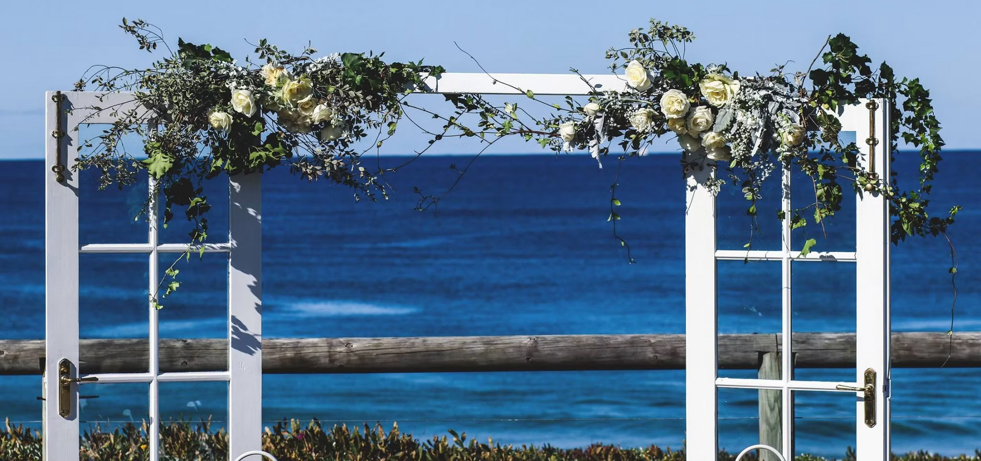 A White Arch With Flowers on It Overlooking the Ocean ― Central Coast Events in Berkeley Vale, NSW