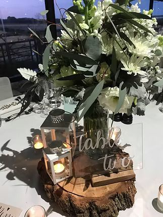 A Table With a Vase of Flowers and Candles on It ― Central Coast Events in Berkeley Vale, NSW