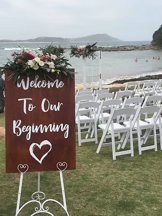 A Sign is Sitting in Front of a Row of White Folding Chairs ― Central Coast Events in Berkeley Vale, NSW