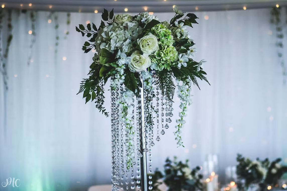 A Tall Vase Filled With Flowers and Crystals is Sitting on a Table ― Central Coast Events in Berkeley Vale, NSW