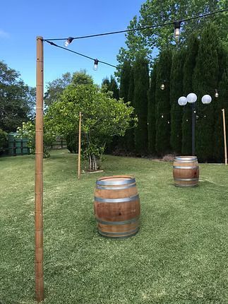 A Couple of Wooden Barrels Sitting on Top of a Lush Green Field ― Central Coast Events in Berkeley Vale, NSW