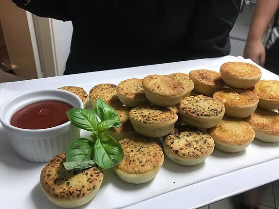 A Person is Holding a Plate of Food With Sauce on It ― Central Coast Events in Berkeley Vale, NSW
