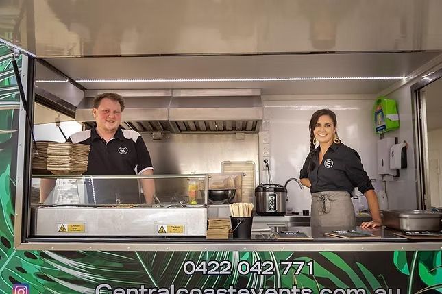 A Man and a Woman Are Standing in Front of a Food Truck ― Central Coast Events in Berkeley Vale, NSW