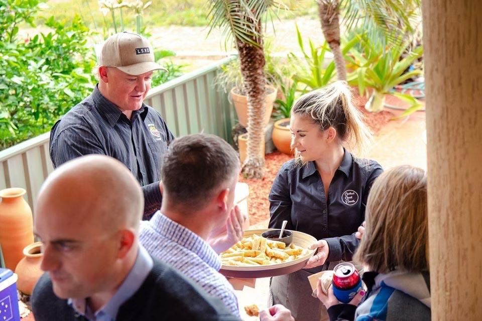 A Group of People Are Sitting Around a Table Eating French Fries ― Central Coast Events in Berkeley Vale, NSW