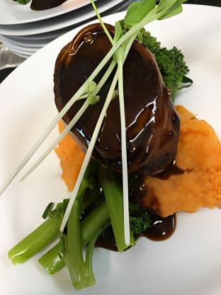 A White Plate Topped With a Piece of Meat and Vegetables ― Central Coast Events in Berkeley Vale, NSW