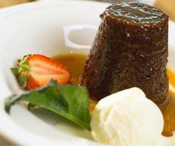 A Close Up of a Dessert With Ice Cream and a Strawberry on a Plate ― Central Coast Events in Berkeley Vale, NSW