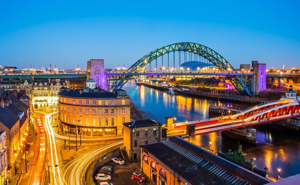 An Aerial View of a Bridge Over a River in a City at Night — Central Coast Events in Newcastle, NSW
