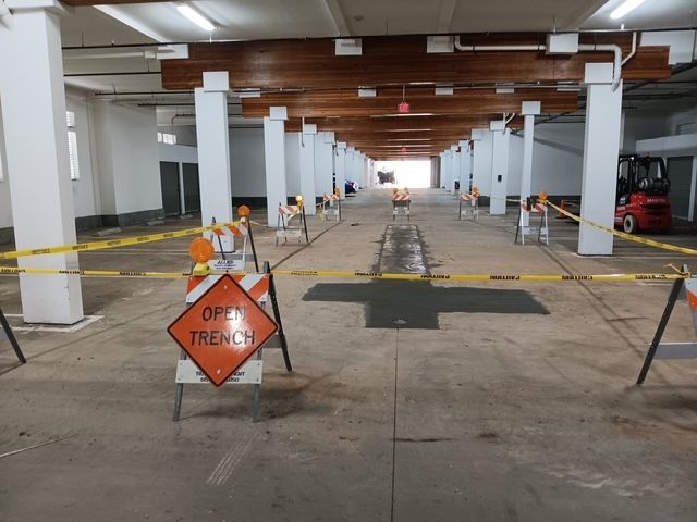 A construction site with a sign that says open trench