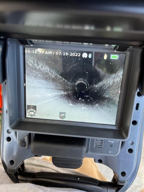 A camera shows a picture of a pipe and the date of 07-18-2022