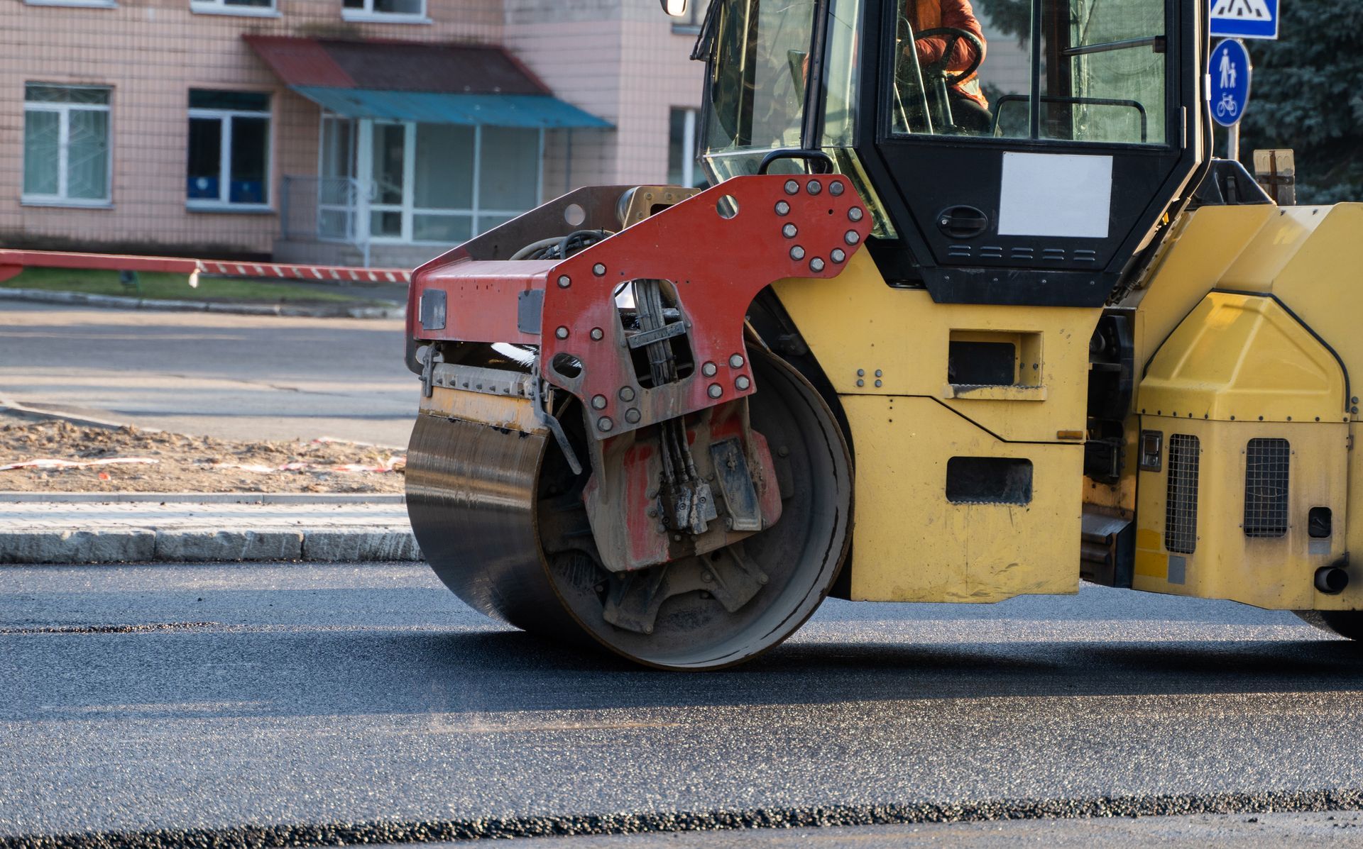 Asphalt repair with a steamroller on a city street.