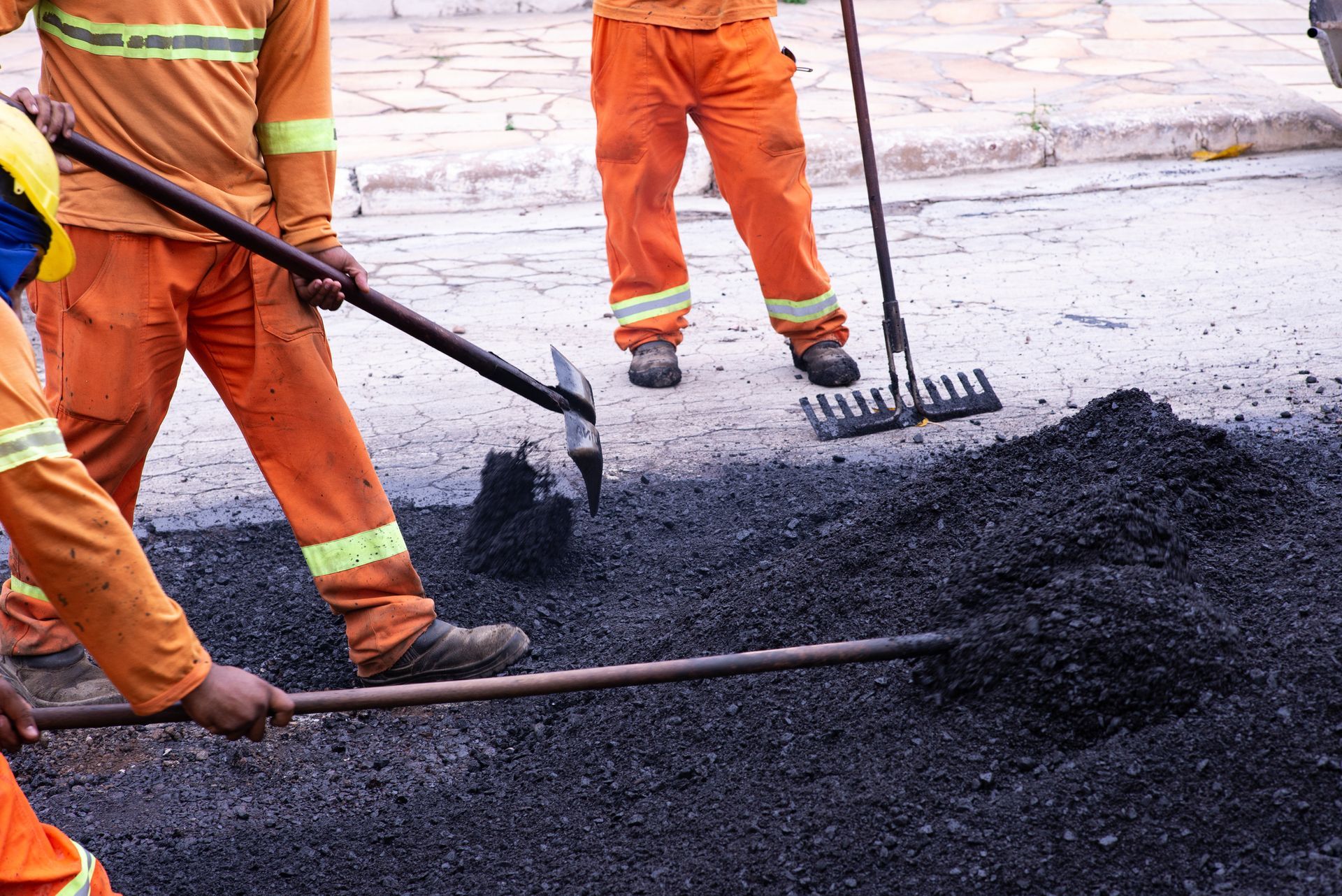 Workers from Ace Asphalt are doing high-quality asphalt repair in Raleigh, NC, ensuring smooth and d