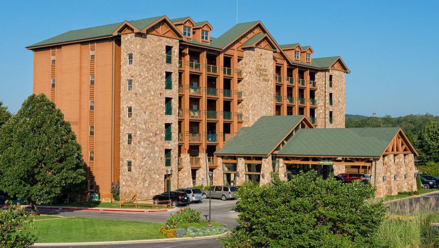 A large building with arches and a car parked in front of it.