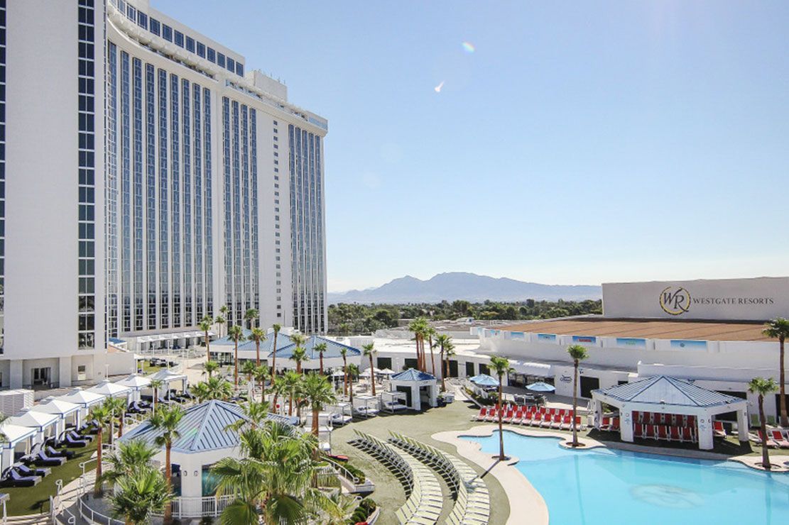 An aerial view of a beach with a hotel in the background.