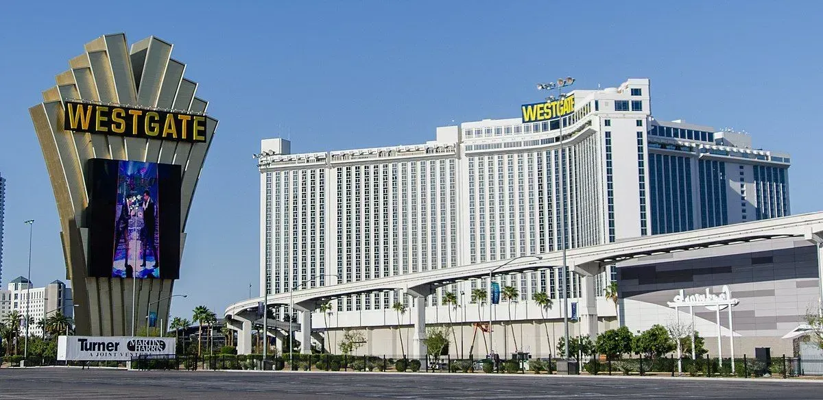 A large building with arches and a car parked in front of it.