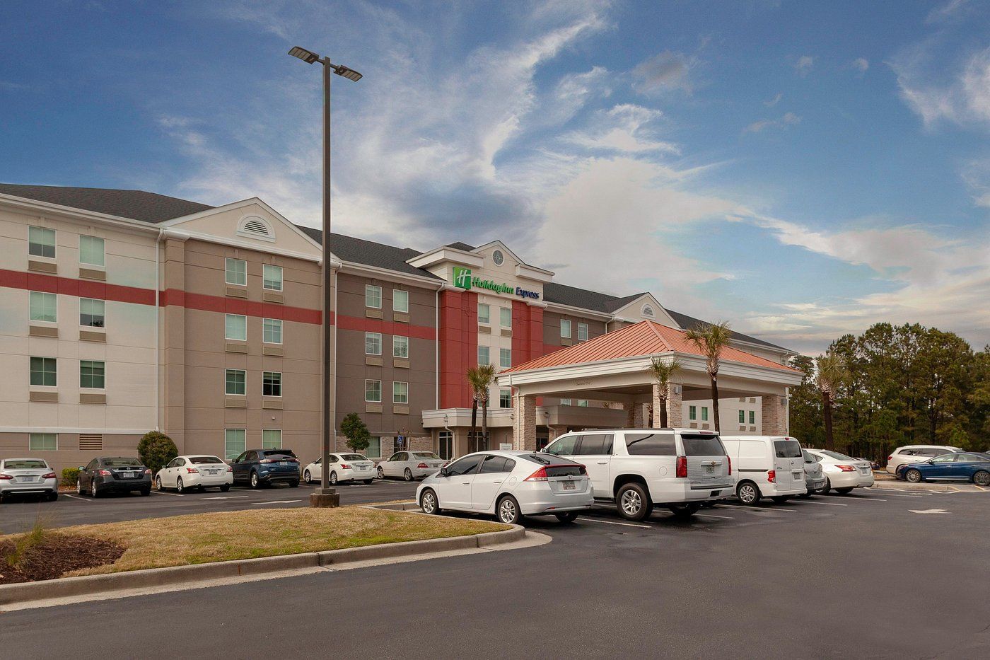 A large building with arches and a car parked in front of it.