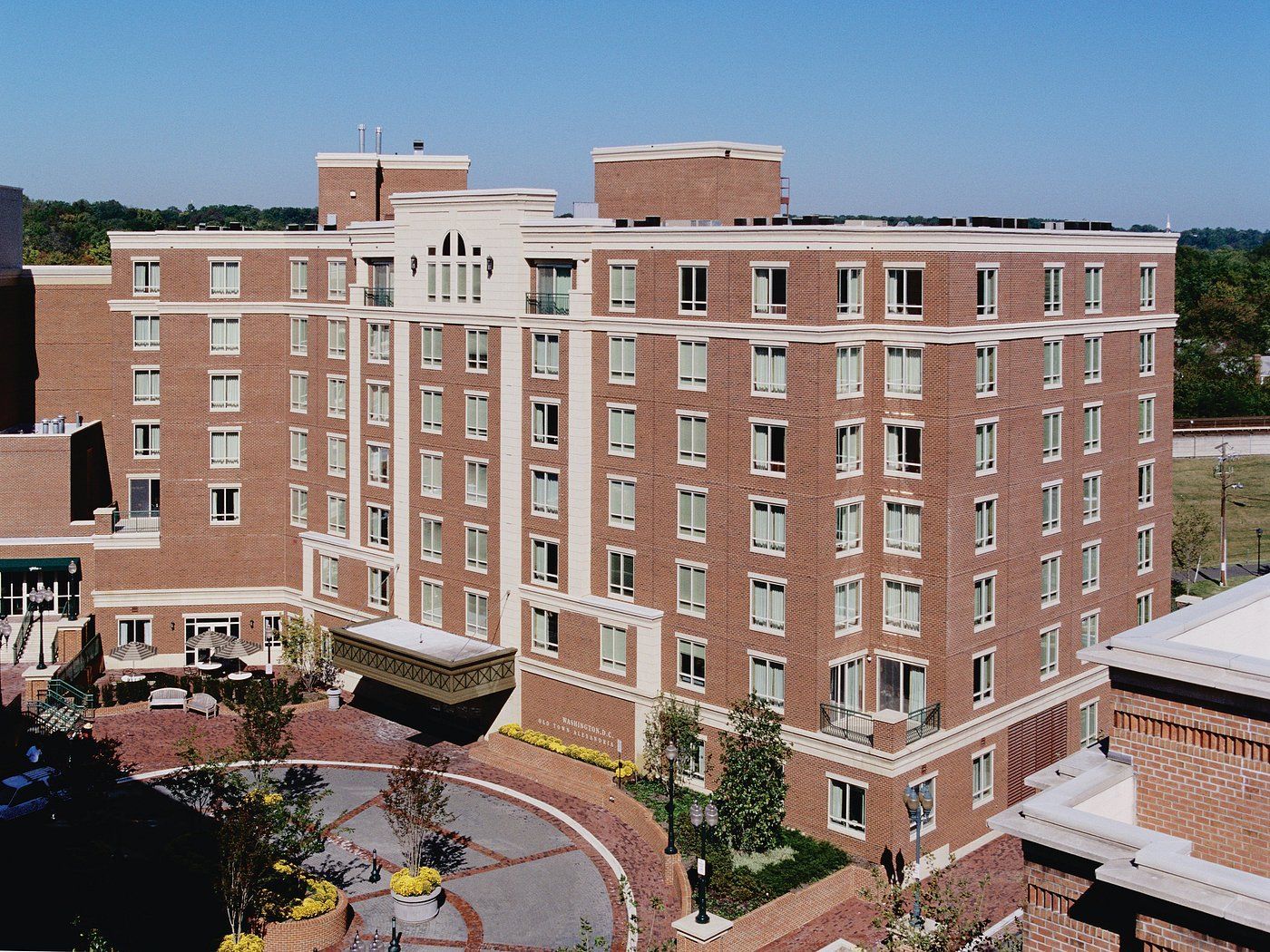 A large building with arches and a car parked in front of it.