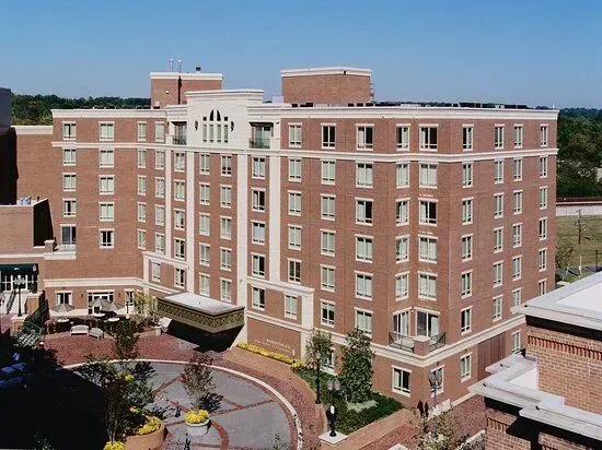 A large building with arches and a car parked in front of it.