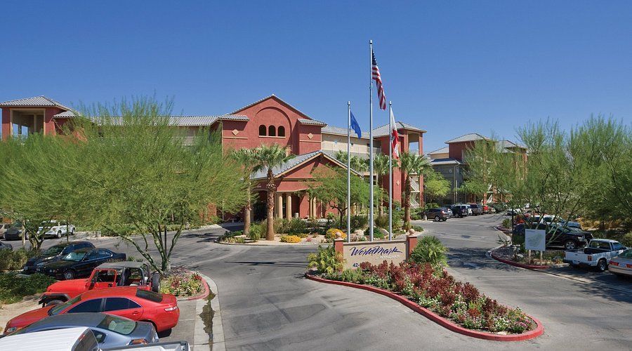 A large building with arches and a car parked in front of it.