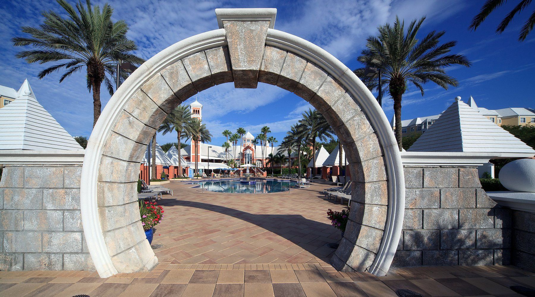 A large building with arches and a car parked in front of it.