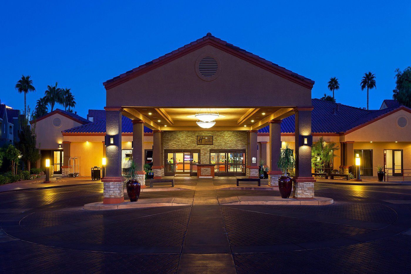 A large building with arches and a car parked in front of it.