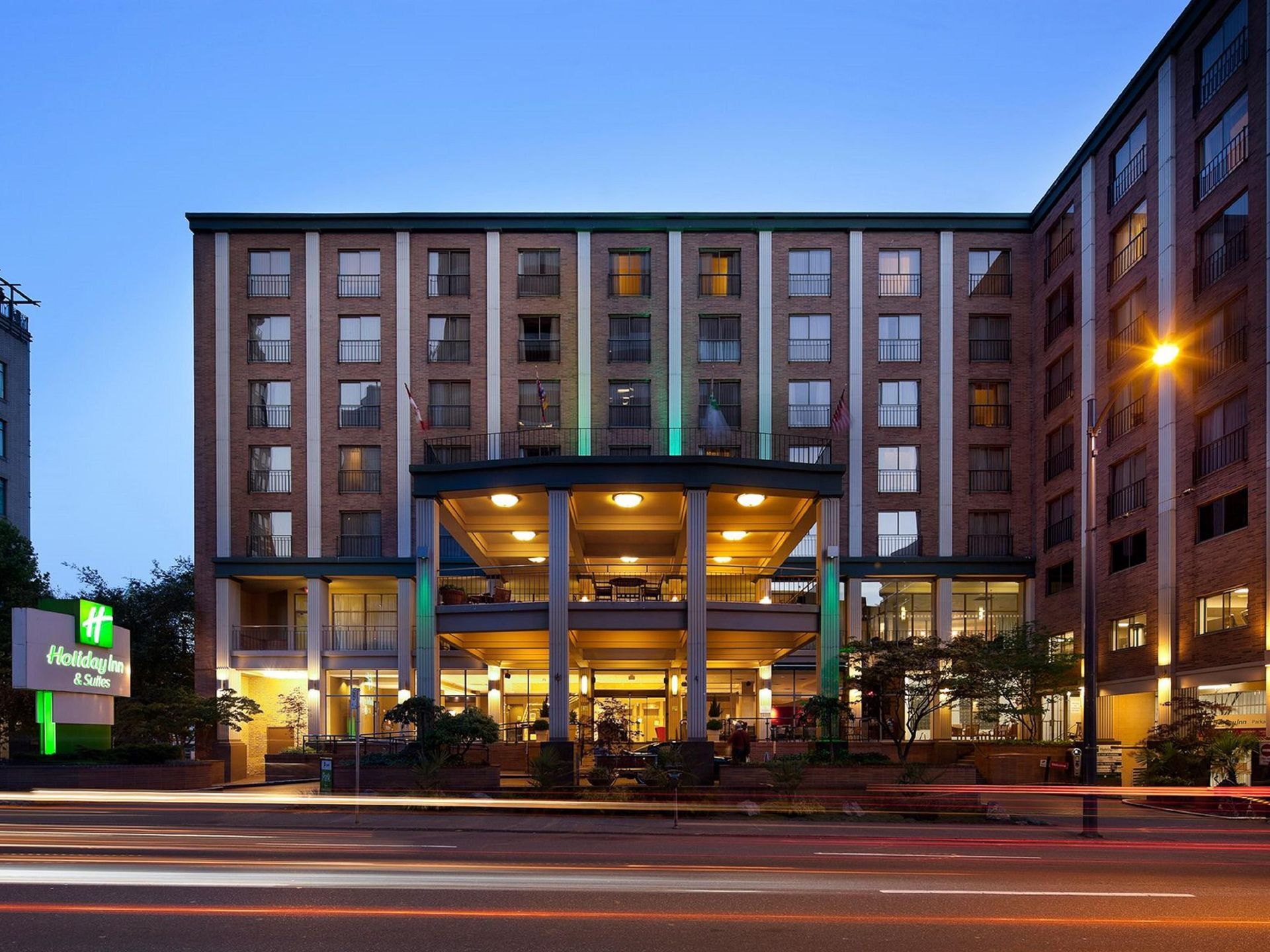 A large building with arches and a car parked in front of it.