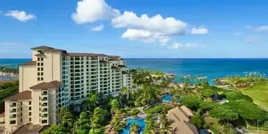 An aerial view of a large hotel next to the ocean.