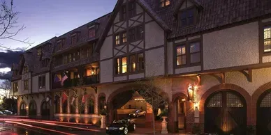 A large building with arches and a car parked in front of it.