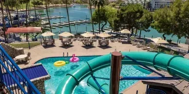 An aerial view of a water park with a water slide and a swimming pool.