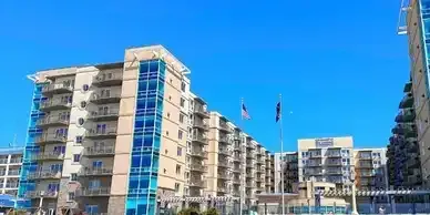 A large apartment building with a blue sky in the background.