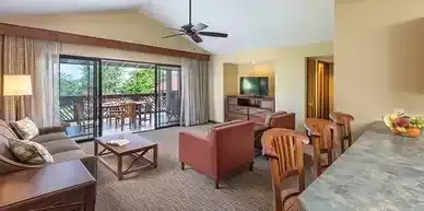 A living room filled with furniture and a ceiling fan.