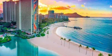 An aerial view of a beach with palm trees and a large building in the background.