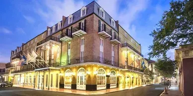 A large brick building with a lot of windows is lit up at night.