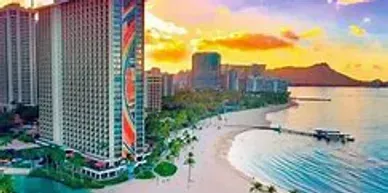 An aerial view of a large building next to a beach.