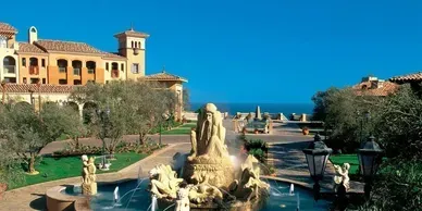 A large building with a fountain in front of it